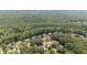 An aerial view of a neighborhood with lush green trees and well-maintained homes at 735 River Ridge Ln, Suwanee, GA 30024