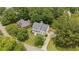 Expansive aerial view of home nestled within a lush, tree-filled neighborhood, showcasing its serene setting at 735 River Ridge Ln, Suwanee, GA 30024