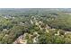 Panoramic aerial shot of a neighborhood surrounded by dense forest, offering privacy and natural beauty at 735 River Ridge Ln, Suwanee, GA 30024