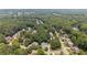 An elevated view of a tree-lined neighborhood features beautiful houses near a river at 735 River Ridge Ln, Suwanee, GA 30024