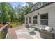 Relaxing back deck features outdoor seating and views of the lush backyard at 735 River Ridge Ln, Suwanee, GA 30024
