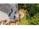 Overhead view of backyard showing a multi-level deck, stone patio with seating, and manicured lawn at 735 River Ridge Ln, Suwanee, GA 30024