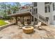 Backyard patio with a fire pit, seating, and stairs leading to the deck at 735 River Ridge Ln, Suwanee, GA 30024
