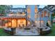 Expansive backyard patio with a stone fire pit, outdoor seating, and a covered deck above, ideal for entertaining at 735 River Ridge Ln, Suwanee, GA 30024
