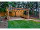 Inviting backyard pergola with string lights, benches, and a paved area perfect for outdoor enjoyment at 735 River Ridge Ln, Suwanee, GA 30024