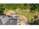 Aerial shot of the backyard, featuring a wooden deck, stone patio with fire pit, and landscaped garden at 735 River Ridge Ln, Suwanee, GA 30024