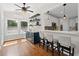 Charming bar area featuring a beverage cooler, open shelving, and seating area to the open-concept kitchen at 735 River Ridge Ln, Suwanee, GA 30024