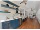 Stylish bar area with blue cabinetry, white countertop, wine cooler, and floating shelves perfect for entertaining guests at 735 River Ridge Ln, Suwanee, GA 30024