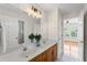 Well-lit bathroom featuring double vanity with marble countertop, warm-toned cabinetry, and neutral paint at 735 River Ridge Ln, Suwanee, GA 30024
