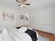 Bedroom with french doors, built-ins and plush bed with black accents and view of staircase at 735 River Ridge Ln, Suwanee, GA 30024