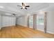 Bright bedroom with hardwood floors, ceiling fan, and large windows with curtains at 735 River Ridge Ln, Suwanee, GA 30024