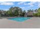 Large community pool with plenty of lounge chairs and seating surrounded by tall trees at 735 River Ridge Ln, Suwanee, GA 30024