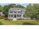 Charming home with manicured lawn and landscaping, front porch and black shutters at 735 River Ridge Ln, Suwanee, GA 30024