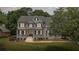 Charming home with manicured lawn and landscaping, front porch and black shutters at 735 River Ridge Ln, Suwanee, GA 30024