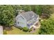 Beautifully landscaped home exterior featuring a welcoming front porch and lush greenery at 735 River Ridge Ln, Suwanee, GA 30024