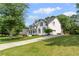 Expansive two-story traditional home with black shutters and a well-manicured front lawn at 735 River Ridge Ln, Suwanee, GA 30024
