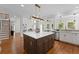 Spacious kitchen with a large central island, stainless steel appliances, and hardwood flooring at 735 River Ridge Ln, Suwanee, GA 30024