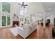 Bright living room with fireplace, high ceilings, large windows, and hardwood floors at 735 River Ridge Ln, Suwanee, GA 30024