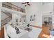 Bright, open living room with hardwood floors, staircase and a soaring two-story ceiling at 735 River Ridge Ln, Suwanee, GA 30024