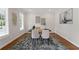Office area with a desk, two chairs, hardwood floors, rug and bright window light at 735 River Ridge Ln, Suwanee, GA 30024
