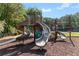 Community playground featuring multiple slides, climbing structures, and a soft landing surface at 735 River Ridge Ln, Suwanee, GA 30024