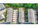 Aerial view of townhomes featuring two car garages and landscaping in a thriving community, unit outlined in yellow at 747 Topsail Ln, Alpharetta, GA 30005