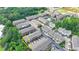 Aerial view of townhomes featuring two car garages and landscaping in a thriving community, unit outlined in yellow at 747 Topsail Ln, Alpharetta, GA 30005