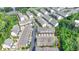 Aerial view of townhomes featuring two car garages and landscaping in a thriving community, unit outlined in yellow at 747 Topsail Ln, Alpharetta, GA 30005