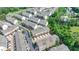 Aerial view of townhomes featuring two car garages and landscaping in a thriving community with tree lined streets at 747 Topsail Ln, Alpharetta, GA 30005