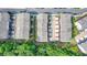 Aerial view of townhomes featuring two car garages, and landscaped islands between units in a thriving community at 747 Topsail Ln, Alpharetta, GA 30005