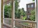 Private balcony offers a serene view of lush greenery and the building's exterior at 747 Topsail Ln, Alpharetta, GA 30005