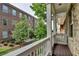 View from balcony overlooks green space and charming brick building at 747 Topsail Ln, Alpharetta, GA 30005