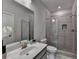 Modern bathroom with a glass-enclosed shower, large mirror, and stylish vanity at 747 Topsail Ln, Alpharetta, GA 30005
