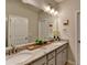 Modern bathroom with double sinks, granite countertop, framed mirrors and modern fixtures at 747 Topsail Ln, Alpharetta, GA 30005