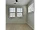 Bright bedroom featuring two windows offering natural light and neutral carpeting at 747 Topsail Ln, Alpharetta, GA 30005