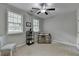 Bright bedroom with two windows, a ceiling fan, and neutral carpet at 747 Topsail Ln, Alpharetta, GA 30005