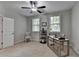 Neutral bedroom with two windows, a ceiling fan, a desk, and neutral carpet at 747 Topsail Ln, Alpharetta, GA 30005