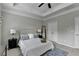 This bedroom features a tray ceiling, ceiling fan, a padded headboard, and a blue rug at 747 Topsail Ln, Alpharetta, GA 30005