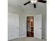 Bedroom with an open doorway leading to a bathroom, and two closed panel doors at 747 Topsail Ln, Alpharetta, GA 30005