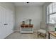 Bedroom featuring a console table with decorative items and a chair by the window at 747 Topsail Ln, Alpharetta, GA 30005