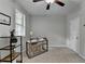 Well-lit bedroom with a ceiling fan, two windows, and a neutral color palette at 747 Topsail Ln, Alpharetta, GA 30005