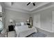 This bedroom features a tray ceiling, ceiling fan, a padded headboard, and a blue rug at 747 Topsail Ln, Alpharetta, GA 30005