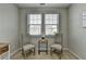 Bright bedroom featuring two chairs, side table, and natural light from the window at 747 Topsail Ln, Alpharetta, GA 30005