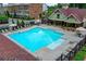 Large rectangular community pool with plenty of lounge seating and a covered area with tables and chairs at 747 Topsail Ln, Alpharetta, GA 30005