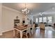 Dining area with hardwood floors connects to the living room, filled with natural light at 747 Topsail Ln, Alpharetta, GA 30005