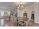 Bright dining area with hardwood floors and pendant lighting open to a contemporary kitchen at 747 Topsail Ln, Alpharetta, GA 30005