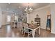Charming dining area open to the kitchen, complete with a stylish chandelier and hardwood floors at 747 Topsail Ln, Alpharetta, GA 30005
