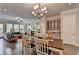 Contemporary dining room with chandelier and seamless flow to the living area at 747 Topsail Ln, Alpharetta, GA 30005