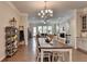 Open-concept dining room with hardwood floors and view to the living room at 747 Topsail Ln, Alpharetta, GA 30005