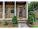 Charming home entrance with a glass paneled front door and lovely landscaping at 747 Topsail Ln, Alpharetta, GA 30005